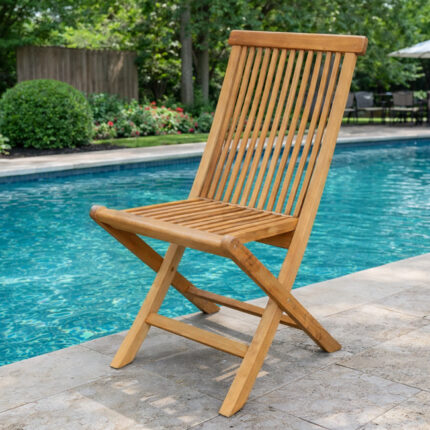 Solid teak folding garden chair with slatted backrest and seat beside a swimming pool