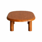 Three-quarter view of the Dio solid teak wood coffee table showing the smooth rounded edges and premium wood grain