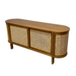 Close-up perspective of the Nala natural teak sideboard highlighting the organic wood grain and curved rattan side panels