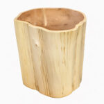 A perspective view of a natural suar wood stump side table featuring a smooth carved-out center, showcasing the organic shape and rich internal wood texture of the suar wood log.