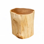 Full studio shot of a solid suar wood log stool with a natural live edge finish, highlighting the vertical wood grain patterns and a unique natural wood knot near the base