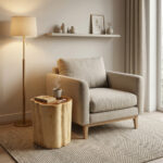 A functional solid wood log stool placed next to a modern beige armchair in a minimalist interior, serving as a coffee table for a book and a steaming mug of tea