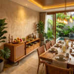 Sora Split Level Teak Credenza crafted from solid teak wood and natural rattan in a luxury tropical modern dining room with warm lighting, a long wooden dining table, and an elegant indoor garden resort ambiance.
