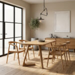 Arch Leg Teak Dining Set with 4 Selly chairs arranged in a bright, minimalist dining room featuring wooden flooring, a large black-framed window, a concrete planter with a tree, and a wooden sideboard cabinet