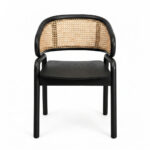 A direct frontal view of the Nara Teak Rattan Wave Chair with a black frame and seat, centered against a white background. This view highlights the symmetry of its curved rattan backrest and the chair’s simple, elegant lines