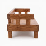 A profile side-on view of the Chunky Solid Suar Wood Bench with Backrest. This shot clearly displays the thickness of the solid Suar (Trembesi) wood blocks on both the backrest and the seat, as well as the minimal yet sturdy leg structure, against a white backdrop.