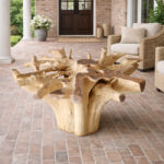 Dhifa natural teak root dining table base in covered patio setting