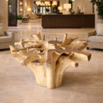 Natural teak root dining table base in contemporary hospitality interior
