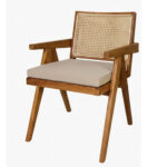 45 degree view of teak wood dining armchair with woven rattan backrest and upholstered seat