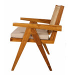 Side view of solid teak wood armchair with rattan backrest and cushioned seat