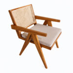 Top angled view of teak armchair showing wooden armrests, rattan backrest, and cushioned seat