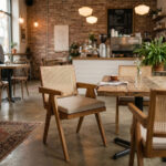 Teak dining armchair with natural rattan backrest paired with a solid wood dining table
