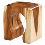 Natural Suar wood grain and curved sculptural opening of the ArcoForm Stool