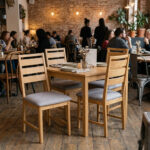 Teak wood dining chairs with upholstered cushions in a restaurant interior