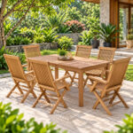 Teak folding garden chairs with wooden armrests arranged around a square teak outdoor dining table