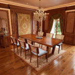 Dhifa Suar wood dining table set with teak rattan chairs in a classic dining room