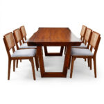 Side view of teak wood dining chair with woven rattan backrest and upholstered seat