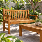 Elevated view of Dhifa teak garden bench and matching wooden coffee table on a garden patio