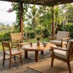 Dio oval teak wood coffee table in teak honey finish on a covered terrace