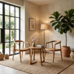 Solid teak Helix Round Table beside lounge chairs in minimalist living room Image Title: