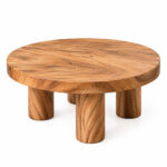 Round suar wood coffee table with a thick circular top and four cylindrical legs on a white background