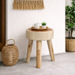 Log Slice Suar Wood Stool with natural wood grain displayed in a covered terrace setting