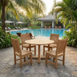 NBF Arvella solid teak outdoor dining chair arranged with a round teak garden table