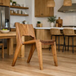 Nara solid Suar wood chair displayed in a contemporary kitchen with natural wood cabinetry