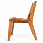 Side profile of Nara solid Suar wood dining chair showing its angled legs and sculptural backrest