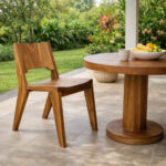 Nara solid Suar wood chair paired with a round solid wood table on a covered terrace