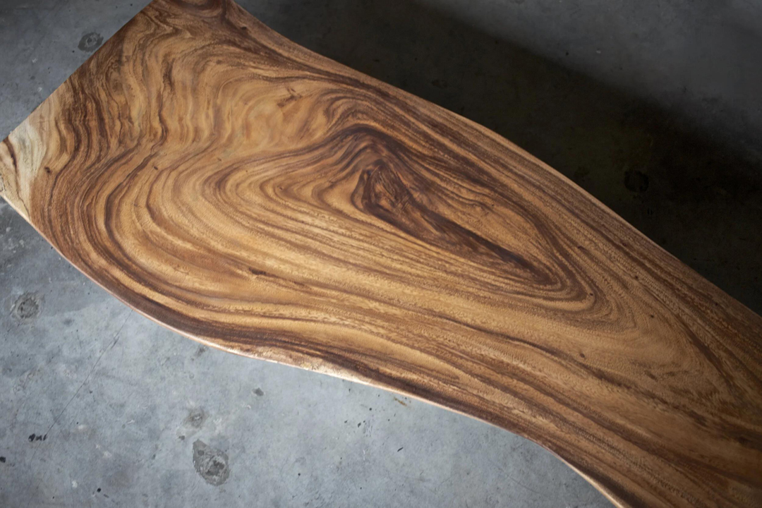 Natural Suar wood grain showing contrasting light sapwood and dark brown heartwood