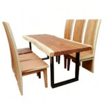 Side view of Suar live-edge slab dining table with black powder-coated metal legs and six wooden chairs