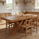 Solid Suar wood dining table with sculptural cross legs in a minimalist dining room Image Title