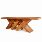Full view of the solid Suar wood dining table with a sculptural interlocking leg base