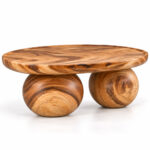 Side profile of Nuvora Suar wood coffee table showing the oval tabletop and twin rounded bases