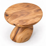 Top view of the Orvella round Suar wood side table beside a sofa