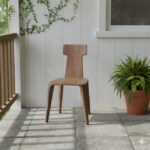 Solid Suar wood chair with geometric T-backrest on a covered terrace