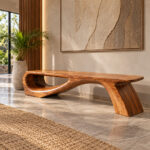Suar Wood Continuum Bench front view in contemporary interior with sculptural wooden design