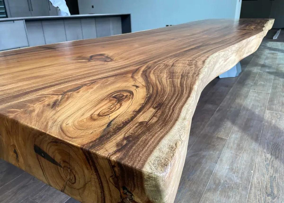 Wide Suar wood slab with distinctive grain patterns and natural live edges