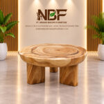 Suarora Triform round Suar wood coffee table displayed in a wooden furniture studio