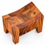 Top view of Suarvo Sculptural Stool showing its curved seat and natural wood grain