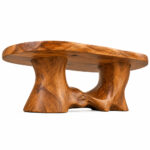 Underside view of the Sylvara Suar wood coffee table showing its sculptural base and tabletop construction