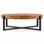 Side profile of the Teakora round coffee table with a thick wood top and black cross base