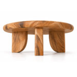 Trivana solid Suar wood coffee table showing rounded tabletop edge and sculptural three-leg base from below