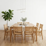 Full view of teak wood dining chair with woven rattan seat and backrest