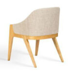 Rear view of a Scandinavian teak dining chair showing the upholstered backrest and tapered wooden legs