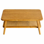 Teak wood coffee table with rounded rectangular tabletop and rattan shelf