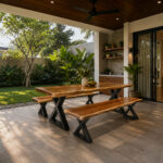 X-Forge solid Suar wood dining table with two benches and black X-frame metal legs in a semi-outdoor dining area